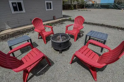 a group of four red chairs and a fire pit at Cozy and Budget Friendly Single Bedroom in the Heart of Denver in Denver