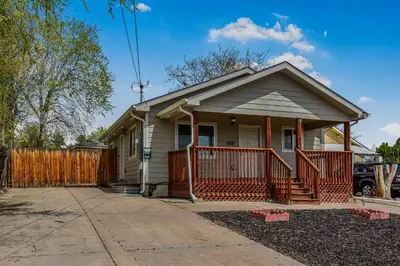 a small house with a fence in front of it at Cozy and Budget Friendly Single Bedroom in the Heart of Denver in Denver