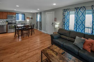 a living room with a couch and a table at Cozy and Budget Friendly Single Bedroom in the Heart of Denver in Denver