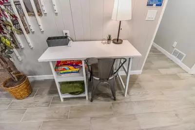 a table with a lamp on top of a floor at Vibrant & Cozy Two Bedroom Lower Unit King Beds in Denver