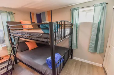 a bunk bed room with two bunk beds in a house at Vibrant & Cozy Two Bedroom Lower Unit King Beds in Denver