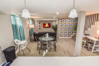 a living room and dining room with a table and chairs at Vibrant & Cozy Two Bedroom Lower Unit King Beds in Denver