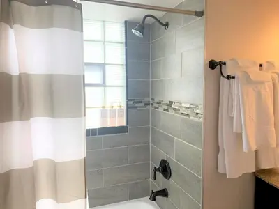 a bathroom with a shower with a shower curtain at Family Friendly & Cozy Two Bedroom Denver in Denver
