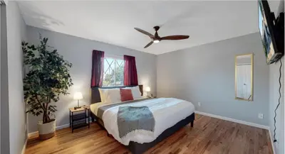 a bedroom with a bed and a ceiling fan at Updated Family Unit with Two King Beds in Denver