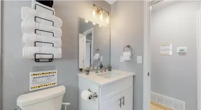 a bathroom with a sink and a toilet and a mirror at Updated Family Unit with Two King Beds in Denver
