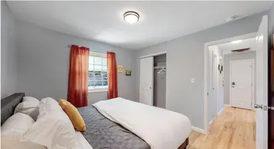 a bedroom with a large bed and a window at Updated Family Unit with Two King Beds in Denver