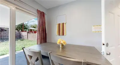 a dining room with a wooden table and chairs at Updated Family Unit with Two King Beds in Denver