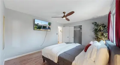 a bedroom with a bed and a ceiling fan at Updated Family Unit with Two King Beds in Denver