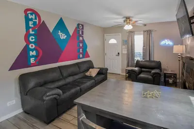 a living room with a couch and a table at Cozy upper unit great for family visiting Zoo medica campus and downtown in Denver