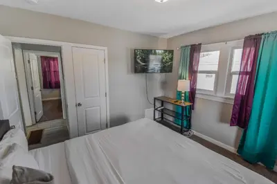 a bedroom with a white bed and a window at Cozy upper unit great for family visiting Zoo medica campus and downtown in Denver
