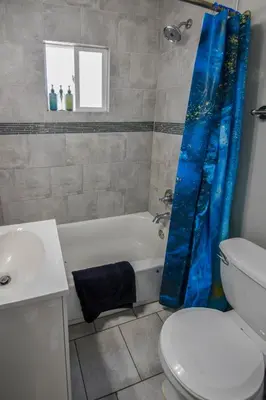 a bathroom with a tub and a toilet and a sink at Cozy upper unit great for family visiting Zoo medica campus and downtown in Denver