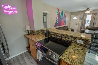 a kitchen with a stove and a counter top at Cozy upper unit great for family visiting Zoo medica campus and downtown in Denver