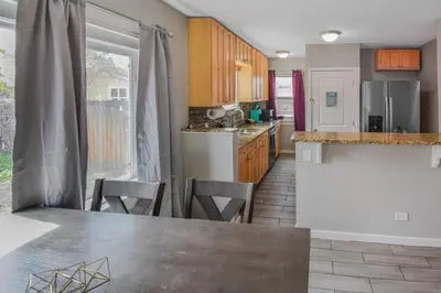 a kitchen with a table and chairs in a kitchen at Cozy upper unit great for family visiting Zoo medica campus and downtown in Denver