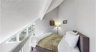 a white bedroom with a bed and a window at Updated Two-Bedroom with Three King Beds Loft & Two Baths in Aurora