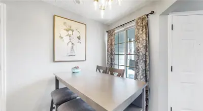 a dining room with a table and chairs and a window at Updated Two-Bedroom with Three King Beds Loft & Two Baths in Aurora