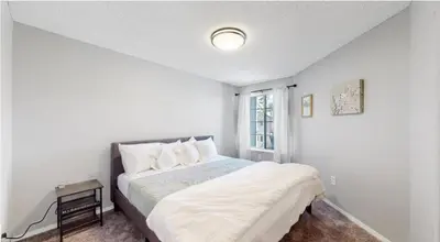 a white bedroom with a bed and a window at Updated Two-Bedroom with Three King Beds Loft & Two Baths in Aurora