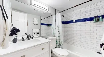 a white bathroom with a sink and a toilet at Updated Two-Bedroom with Three King Beds Loft & Two Baths in Aurora