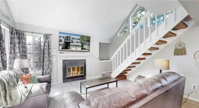 a living room with a couch and a fireplace at Updated Two-Bedroom with Three King Beds Loft & Two Baths in Aurora