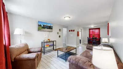 a living room with couches and a table at Cozy King Bed Hideaway Near Top Concerts & Sports in Commerce City