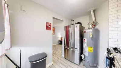 a kitchen with a stainless steel refrigerator in a room at Cozy King Bed Hideaway Near Top Concerts & Sports in Commerce City