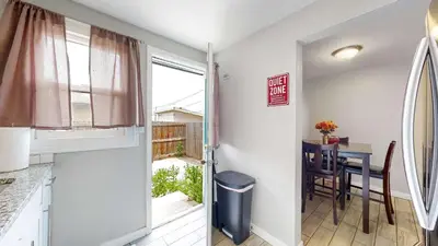 a kitchen and dining room with a table and a window at Cozy King Bed Hideaway Near Top Concerts & Sports in Commerce City