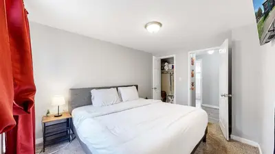 a bedroom with a large white bed in it at Cozy King Bed Hideaway Near Top Concerts & Sports in Commerce City