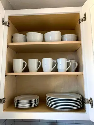 a cabinet filled with plates and cups and dishes at Great Updated King Bed Near Denver Sports field and concerts in Commerce City