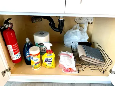 a drawer in a cabinet filled with cleaning products at Great Updated King Bed Near Denver Sports field and concerts in Commerce City