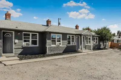 a black house with a lot of windows at Great Updated King Bed Near Denver Sports field and concerts in Commerce City
