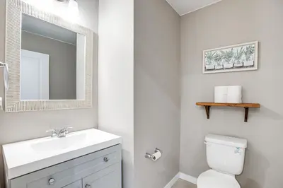 a bathroom with a sink and a toilet and a mirror at Perfect for Families! Quiet Aurora Home in Aurora