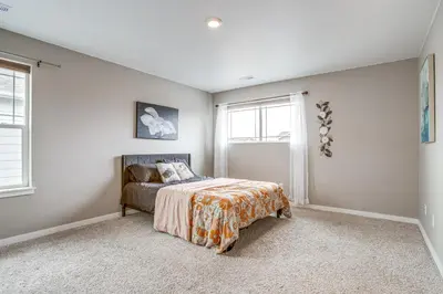 a bedroom with a bed and a window at Perfect for Families! Quiet Aurora Home in Aurora
