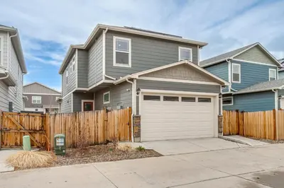 a house with a fence and a garage at Perfect for Families! Quiet Aurora Home in Aurora