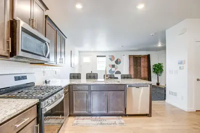a kitchen with a stove and a microwave at Perfect for Families! Quiet Aurora Home in Aurora
