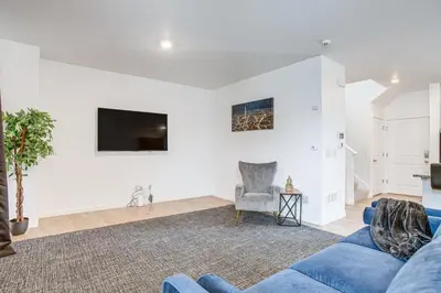 a living room with a blue couch and a tv at Perfect for Families! Quiet Aurora Home in Aurora