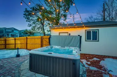 a hot tub in a yard next to a house at Charming Central Denver Bungalow With Hot Tub in Denver