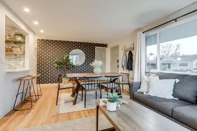 a living room with a couch and a table at Charming Central Denver Bungalow With Hot Tub in Denver