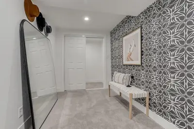 a dressing room with a mirror and a bench at The Western Retreat With Hot Tub and Spacious Yard in Westminster