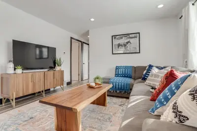 a living room with a couch and a table at The Western Retreat With Hot Tub and Spacious Yard in Westminster