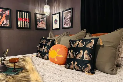 a bedroom with a bed with pillows at NEW The Emerald Haus Near Regis and Denver in Denver