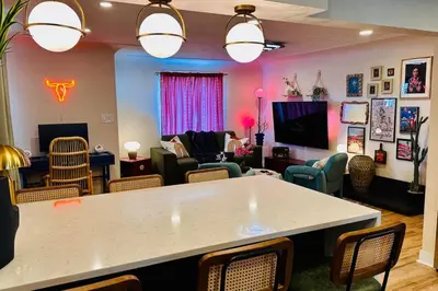 a living room with a table and chairs at NEW The Emerald Haus Near Regis and Denver in Denver