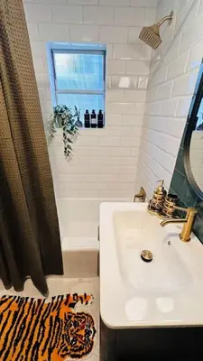 a white bathroom with a sink and a shower at NEW The Emerald Haus Near Regis and Denver in Denver