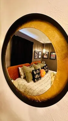 a mirror reflecting a bed in a bedroom at NEW The Emerald Haus Near Regis and Denver in Denver