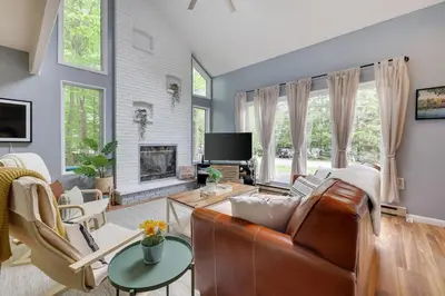 a living room with a couch and a tv at Urban Oasis in the Heart of Denver with Hot tub in Denver