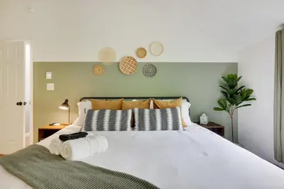 a bedroom with a white bed with towels on it at Urban Oasis in the Heart of Denver with Hot tub in Denver