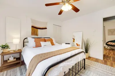 a bedroom with a large bed with a ceiling fan at Urban Oasis in the Heart of Denver with Hot tub in Denver