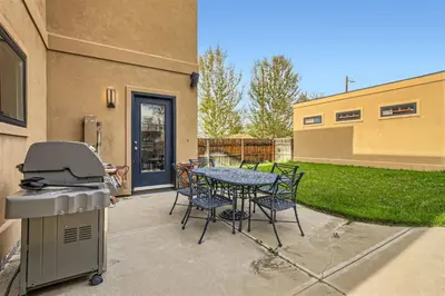 a patio with a table and chairs and a grill at With Pool Table Near to RiNo and City Park in Denver