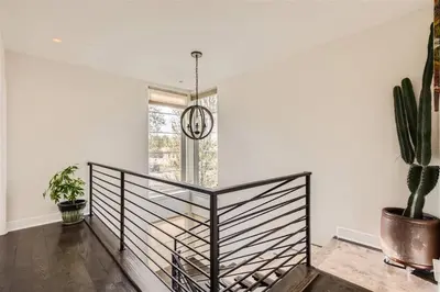 a hallway with a potted plant and a chandelier at With Pool Table Near to RiNo and City Park in Denver