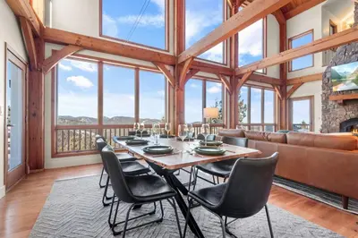 a dining room with a table and chairs and a couch at Mountain Retreat Sleeps 10 with Pool Table and Arcade in Littleton