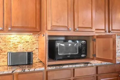 a kitchen with a microwave and a toaster oven at Mountain Retreat Sleeps 10 with Pool Table and Arcade in Littleton