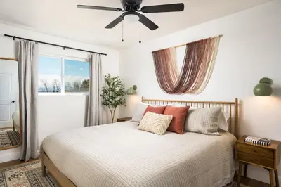 a bedroom with a bed and a ceiling fan at Spacious and Stylish Home with HotTub 12min to Downtown in Westminster